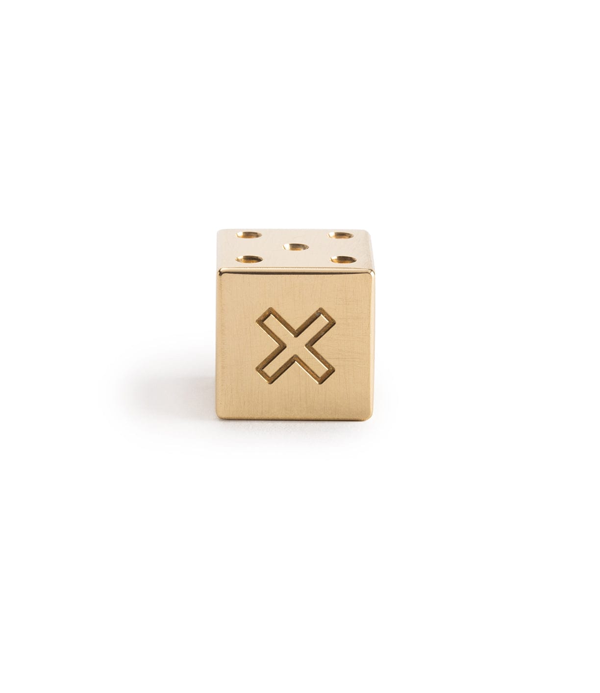 Gold metallic cube with a cut-out X on one side and six circular indentations on the top.