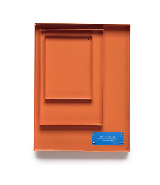 An orange toolbox with a blue plate at the bottom right corner displaying the text Best Made Co. and Made in the USA.