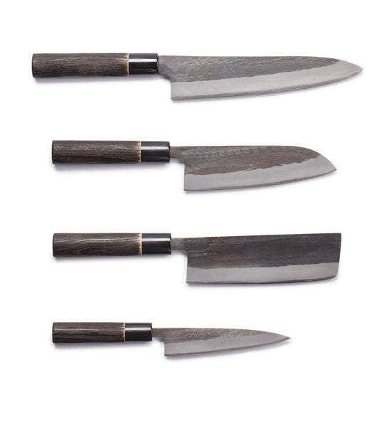 Four Japanese kitchen knives with dark wooden handles are arranged horizontally against a white background.