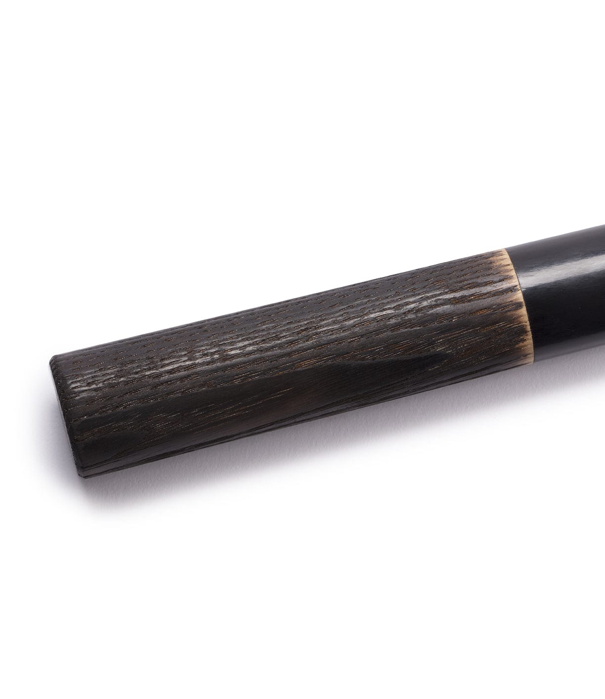 Close-up of a walking cane's handle, made of dark wood with a smooth, polished finish and a slight taper near the end.