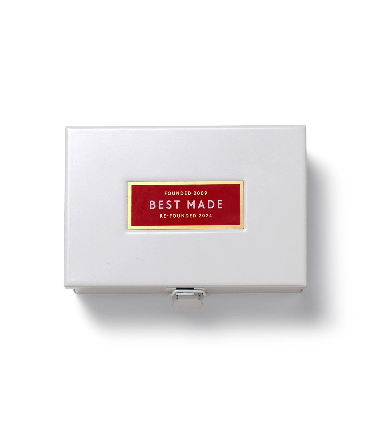 A white box with a metal latch, displaying a red label that reads Founded 2009, Best Made, Re-Founded 2024.