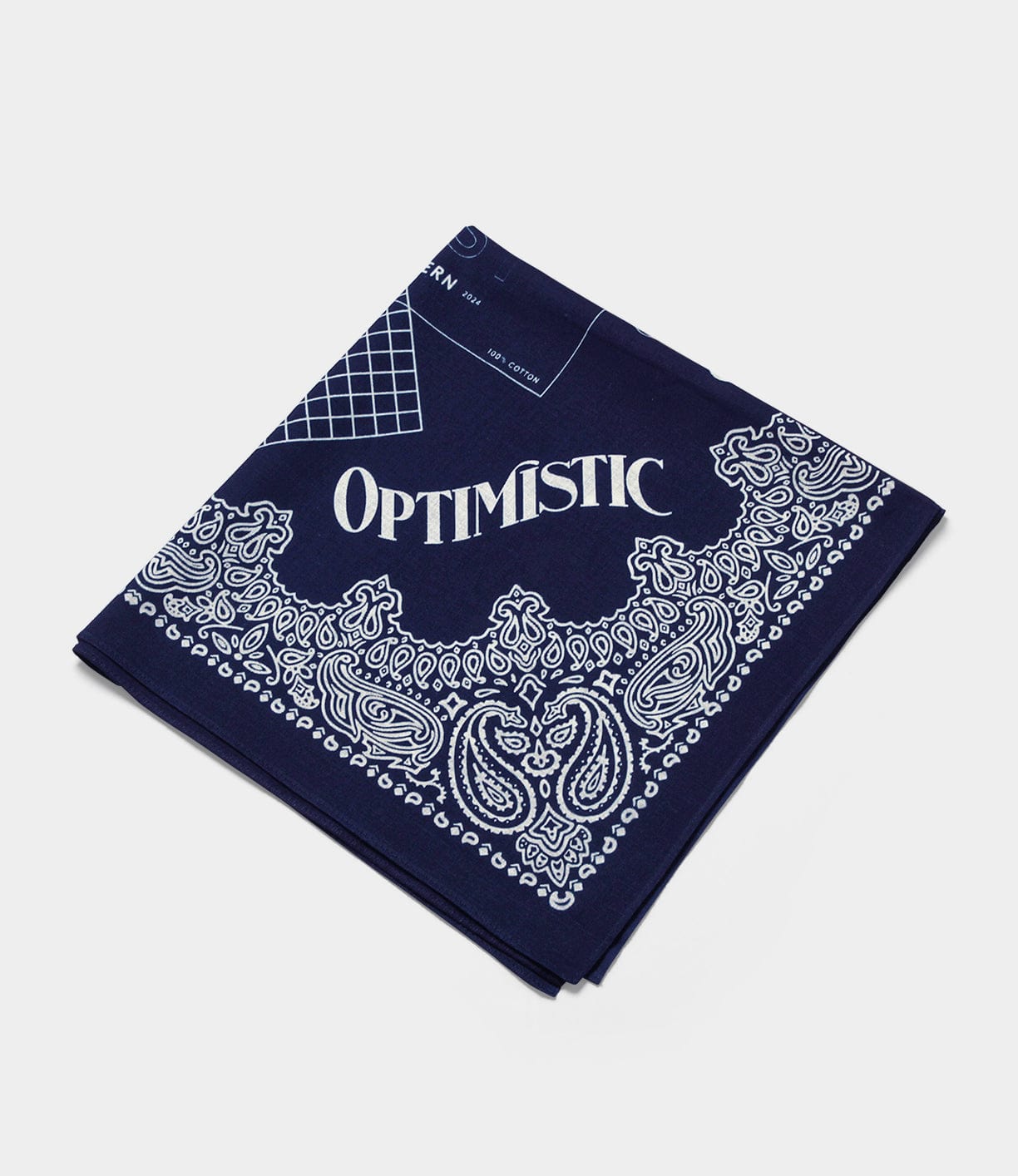 A folded navy blue bandana with white paisley patterns and the word OPTIMISTIC printed in large white letters.