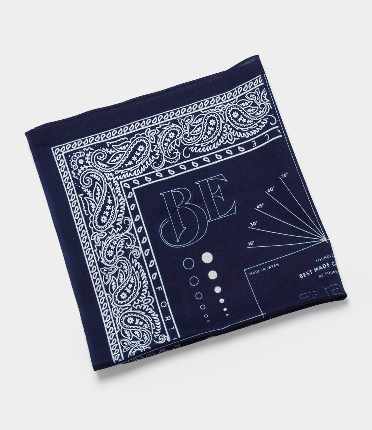 Dark blue, square cloth with white paisley and geometric patterns. It features the letters BE, various technical markings, and the phrase Made in Japan.