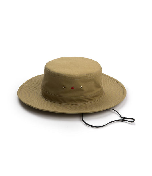 A tan wide-brimmed hat with a red X on the front and a black adjustable chin strap laid flat on a white background.