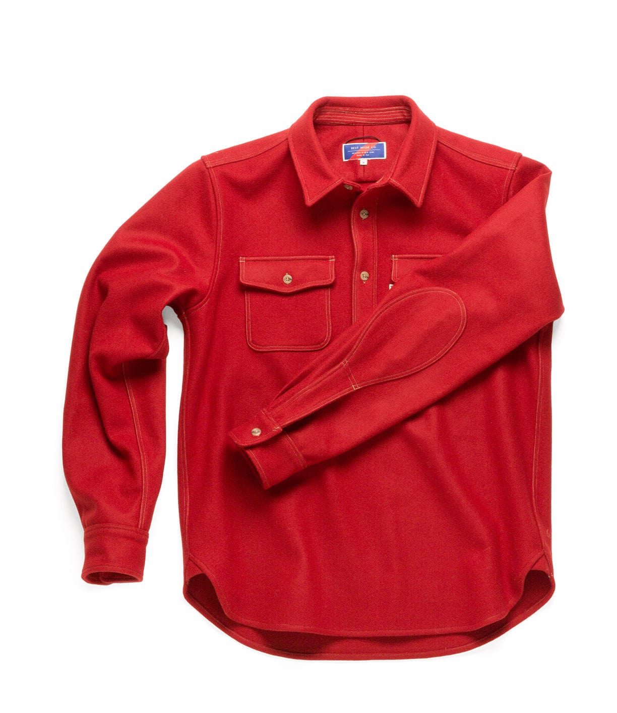 A long-sleeve red button-up shirt with two front pockets and a collar, laid flat.