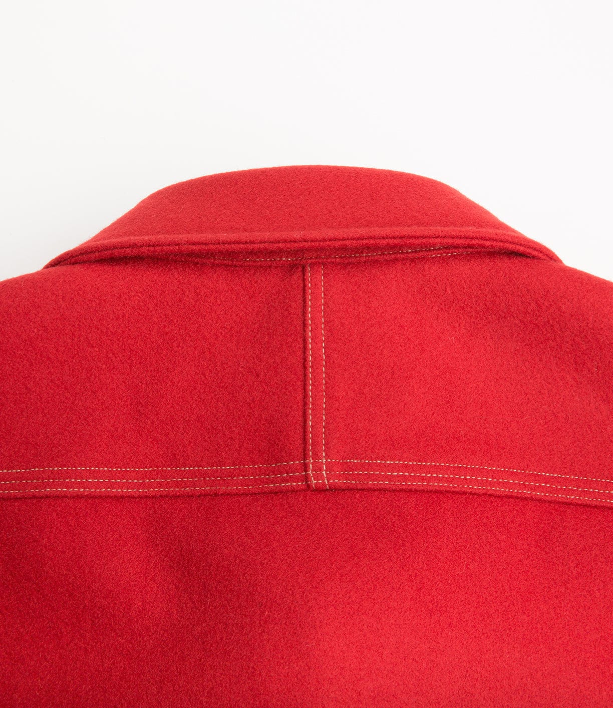 Close-up of the back of a red wool jacket with visible stitching and a collar.